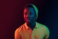 Portrait of a happy young african american man smiling on black neon background Royalty Free Stock Photo