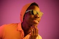 Portrait of a happy young african american man smiling on black neon background Royalty Free Stock Photo