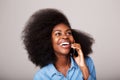 Close up portrait of happy young african american woman laughing and talking on cellphone Royalty Free Stock Photo