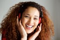 Close up happy young african american woman smiling and listening to music with headphones Royalty Free Stock Photo