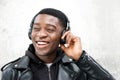 Close up happy young black man listening to music with headphones Royalty Free Stock Photo