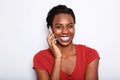 Close up happy young black woman talking on phone by white background Royalty Free Stock Photo