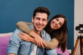 Close up portrait of happy young couple in love, cudding and relaxing in their modern apartment. Smiling wife embracing Royalty Free Stock Photo