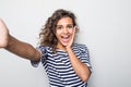 Close up portrait of a happy young curly mulatto woman making selfie against isolated white background Royalty Free Stock Photo