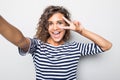 Close up portrait of a happy young curly mulatto woman making selfie against isolated white background Royalty Free Stock Photo