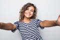 Close up portrait of a happy young curly mulatto woman making selfie against isolated white background Royalty Free Stock Photo