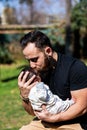 Close-up portrait of happy young father hugging and kissing his sweet adorable newborn child Royalty Free Stock Photo