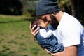 Close-up portrait of happy young father hugging and kissing his sweet adorable newborn child Royalty Free Stock Photo