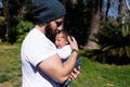 Close-up portrait of happy young father hugging and kissing his sweet adorable newborn child Royalty Free Stock Photo