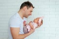 Close-up portrait of happy young father hugging and kissing his sweet adorable newborn child. Happy Family concept Royalty Free Stock Photo