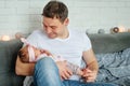 Close-up portrait of happy young father hugging and kissing his sweet adorable newborn child. Happy Family concept Royalty Free Stock Photo