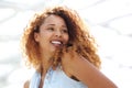 Close up happy young woman with curtly hair looking over shoulder Royalty Free Stock Photo