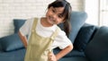 Close up portrait head shot of Asian long black ponytail hair young pretty girl  smiling wearing white shirt and brown bib apron Royalty Free Stock Photo