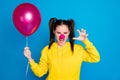 Close-up portrait of her she nice attractive funny aggressive brown-haired girl clown holding in hand air ball