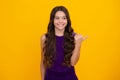 Close-up portrait of her she nice cute attractive cheerful amazed girl pointing aside on copy space isolated on yellow Royalty Free Stock Photo