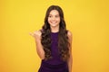 Close-up portrait of her she nice cute attractive cheerful amazed girl pointing aside on copy space isolated on yellow Royalty Free Stock Photo