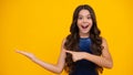 Close-up portrait of her she nice cute attractive cheerful amazed girl pointing aside on copy space isolated on yellow Royalty Free Stock Photo