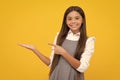 Close-up portrait of her she nice cute attractive cheerful amazed girl pointing aside on copy space isolated on yellow Royalty Free Stock Photo