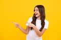 Close-up portrait of her she nice cute attractive cheerful amazed girl pointing aside on copy space isolated on yellow Royalty Free Stock Photo