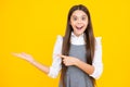 Close-up portrait of her she nice cute attractive cheerful amazed girl pointing aside on copy space isolated on yellow Royalty Free Stock Photo
