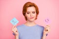 Close-up portrait of her she nice cute charming attractive puzzled girl wearing casual blue t-shirt holding in hands two Royalty Free Stock Photo