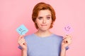 Close-up portrait of her she nice cute charming attractive unsure girl wearing casual blue t-shirt holding in hands two Royalty Free Stock Photo