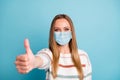 Close-up portrait of her she nice good healthy girl wearing safety gauze mask giving thumbup mers cov influenza