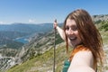 Close up portrait Hiker girl smiling and laughing holding a wood stick. Excursionist red head woman taking a selfie with smart Royalty Free Stock Photo