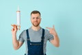 Close-up portrait of his he nice attractive cheerful cheery content guy repairer craftsman isolated over blue color background