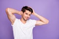 Close-up portrait of his he nice attractive content cheery dreamy brown-haired guy touching soft silky hair isolated