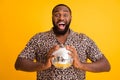 Close-up portrait of his he nice attractive handsome cheerful cheery guy holding in hands glossy disco ball isolated