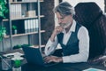 Close-up portrait of his he nice attractive handsome focused gray-haired gentleman sitting in chair searching data on Royalty Free Stock Photo