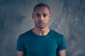 Close-up portrait of his he nice attractive minded calm candid guy wearing casual blue t-shirt over gray concrete wall Royalty Free Stock Photo