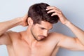 Close-up portrait of his he nice attractive stylish brown-haired guy touching smooth healthy shine hair anti dander