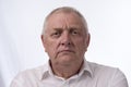 Close up portrait image of a mature man looking annoyed and angry