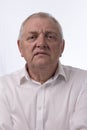 Close up portrait image of a mature man looking annoyed.