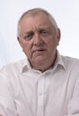 Close up portrait image of a mature man looking confused.