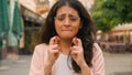 Close up portrait Indian Arabian ethnic woman student businesswoman hopeful girl wish hope crossed fingers praying