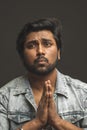 Close up portrait of Indian guy praying the God and asking a help Royalty Free Stock Photo