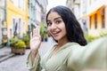 Close-up portrait of an Indian young woman traveling, walking on a city street, filming herself on the phone, talking on Royalty Free Stock Photo