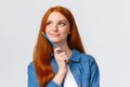 Close-up portrait inspired, dreamy and talented cute redhead woman thinking what draw, holding colored pencil and