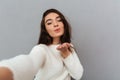 Close-up portrait of joyful brunette woman sending air kiss whil Royalty Free Stock Photo