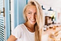 Close-up portrait of laughing blonde woman wears white t-shirt. Outdoor shot of caucasian girl with Royalty Free Stock Photo