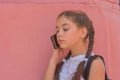 Close up portrait of little beautiful stylish kid girl near red wall as background Royalty Free Stock Photo