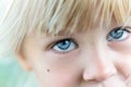 Close-up portrait of little blond caucasian girl. Cute kid with big blue eyes Royalty Free Stock Photo