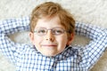 Close-up portrait of little blond kid boy with brown eyeglasses Royalty Free Stock Photo