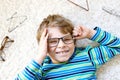 Close-up portrait of little blond kid boy with brown eyeglasses Royalty Free Stock Photo