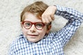 Close-up portrait of little blond kid boy with brown eyeglasses Royalty Free Stock Photo