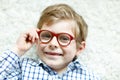 Close-up portrait of little blond kid boy with brown eyeglasses Royalty Free Stock Photo