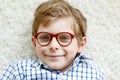 Close-up portrait of little blond kid boy with brown eyeglasses Royalty Free Stock Photo